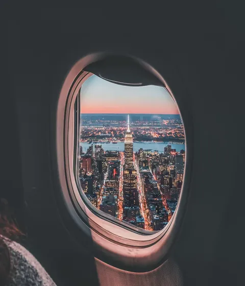 City lights at dusk seen through a window