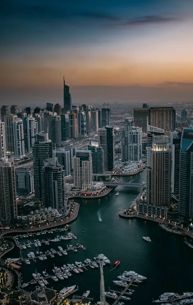 Dubai Marina towers and yachts at dusk