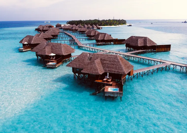 Overwater villas on a turquoise lagoon in the Maldives