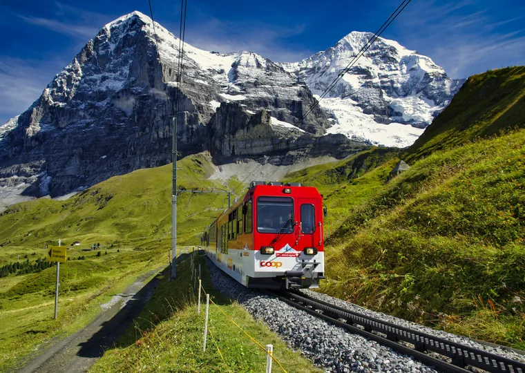 Jungfrau railway train below snowy Swiss peaks
